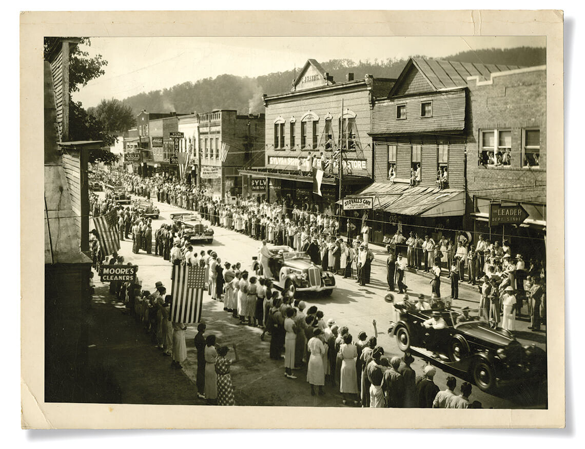 Black and white picture of Roosevelt riding through Sylva's Main Street