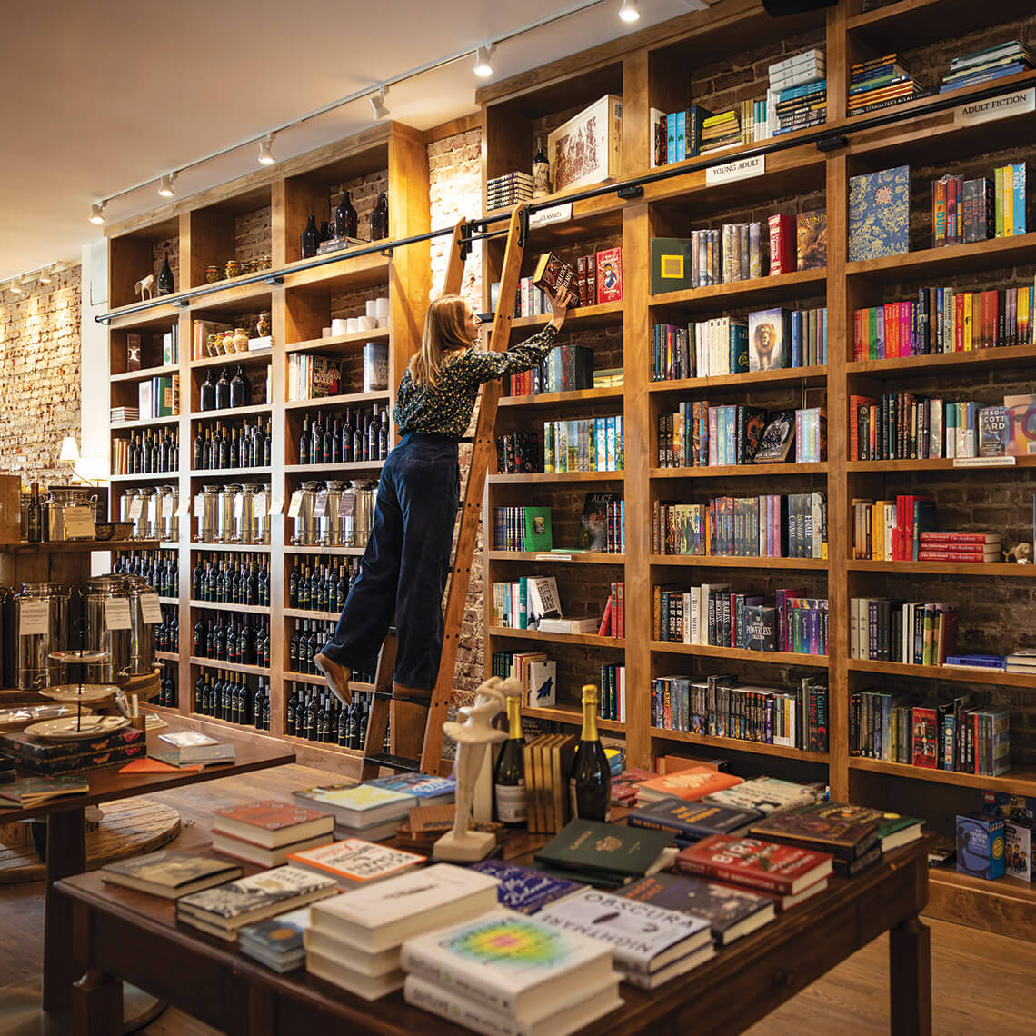 Meredith Davis arranges book selection at Venture Chocolate