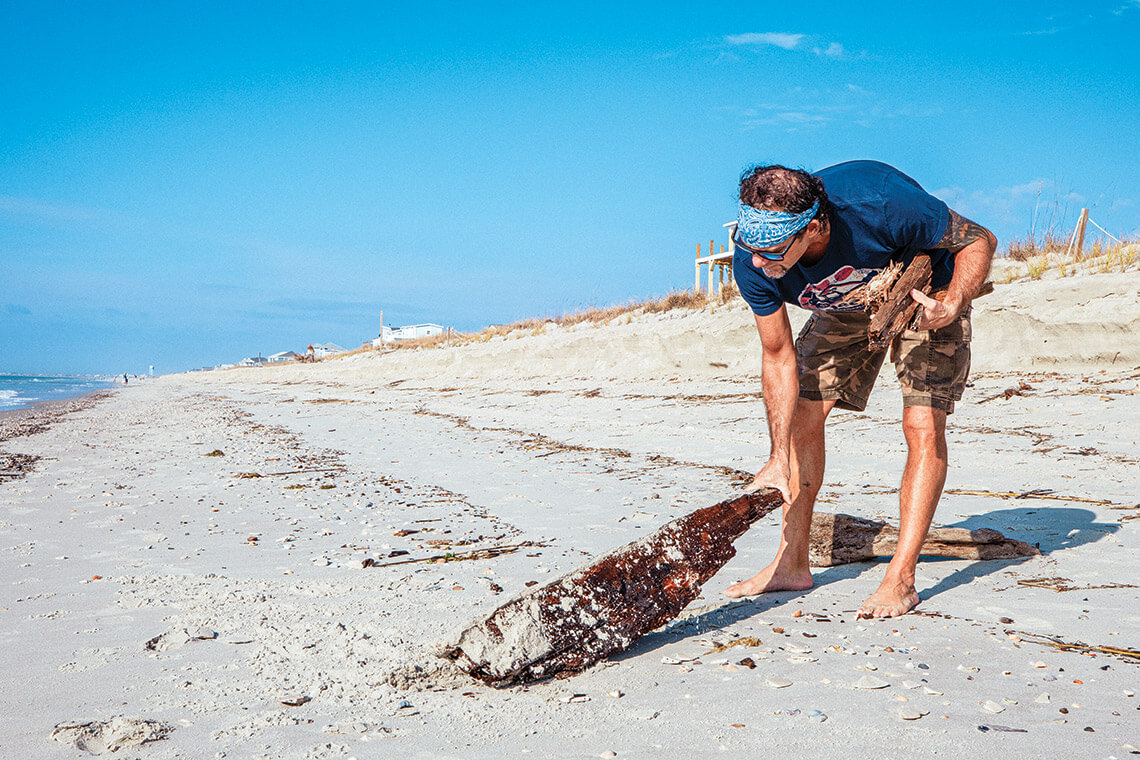 Dean Russel finds driftwood "limbs" on the beach