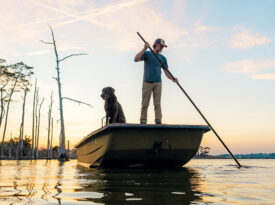 Chandler Sawyer uses a shove pole on his boat