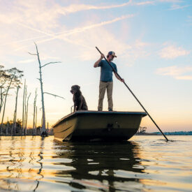 Chandler Sawyer uses a shove pole on his boat