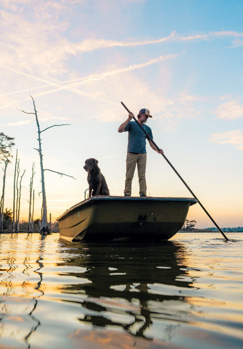 Chandler Sawyer uses a shove pole on his boat
