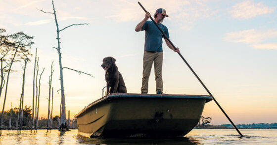 Chandler Sawyer uses a shove pole on his boat