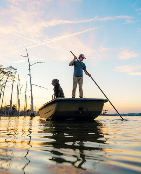 Chandler Sawyer uses a shove pole on his boat