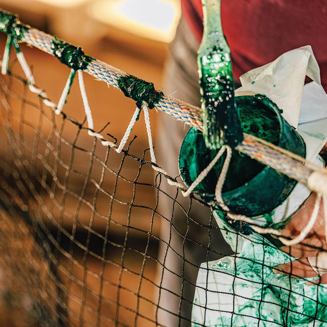 Heidi makes a net at her shop