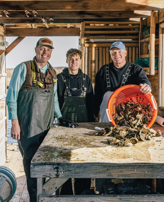 James, Charlie, and Jimmy Morris with a basket of oysters