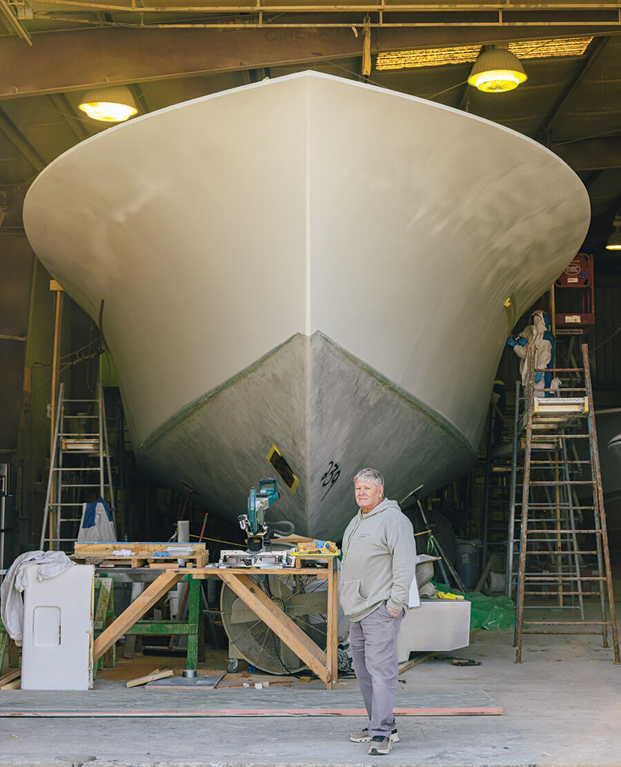 Paul Spencer with one of his yachts in the shop