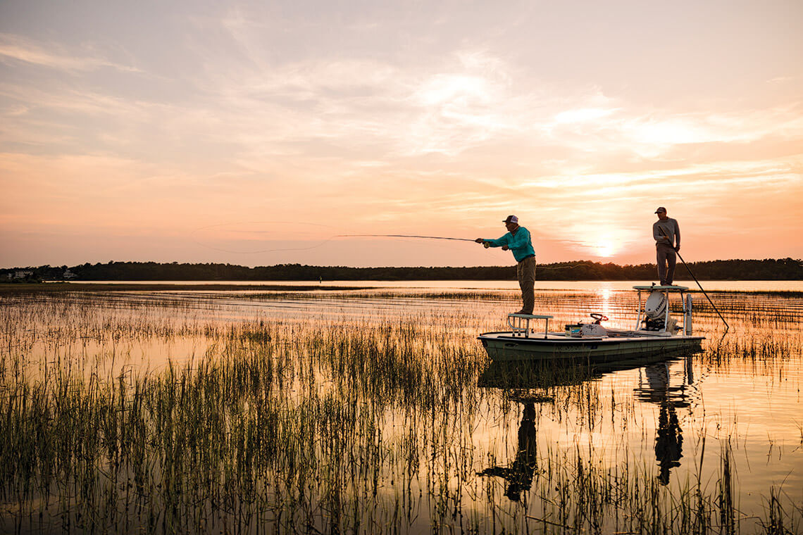 Fishermen cast lines from their skiff in the Cape Fear Estuary