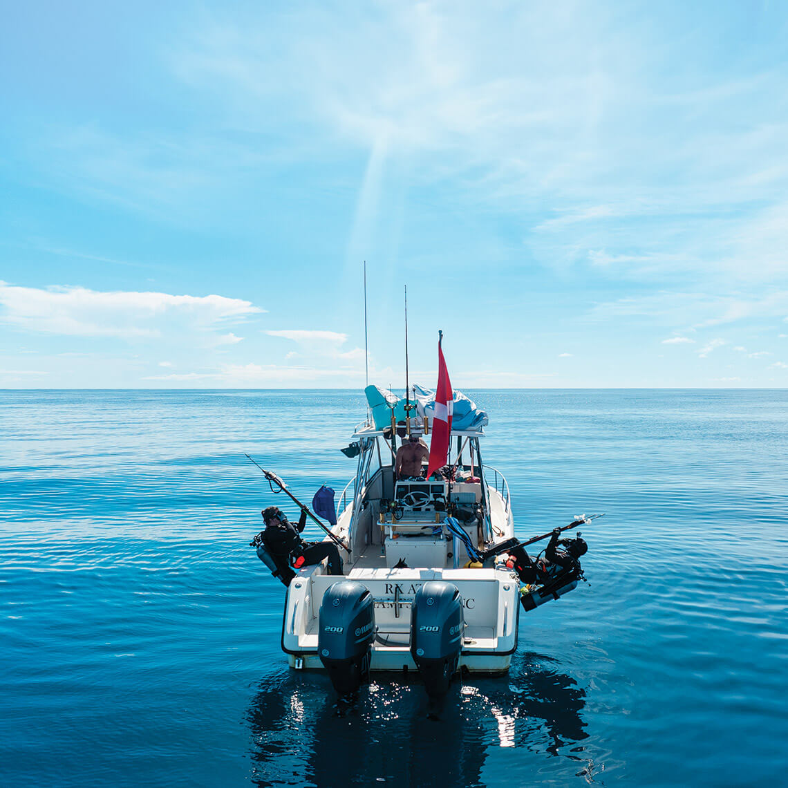 Sarah and James Doss dive from their boat to go spearfishing