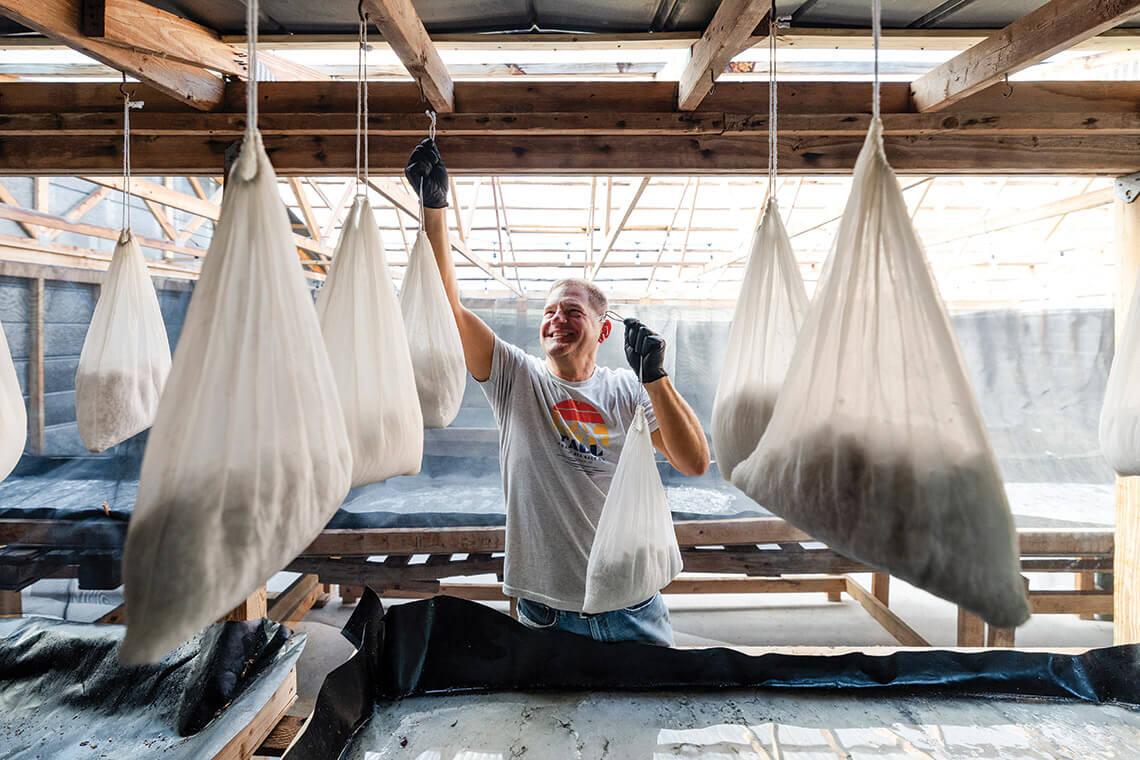 Jason Zombron hangs bags of sea salt