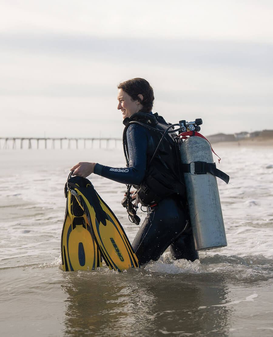The author dressed in scuba gear wades into the water