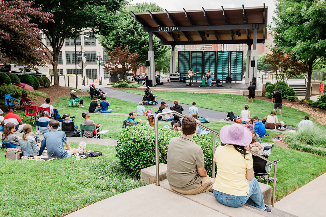 People listen to live music at the Gears & Guitars at Bailey Park