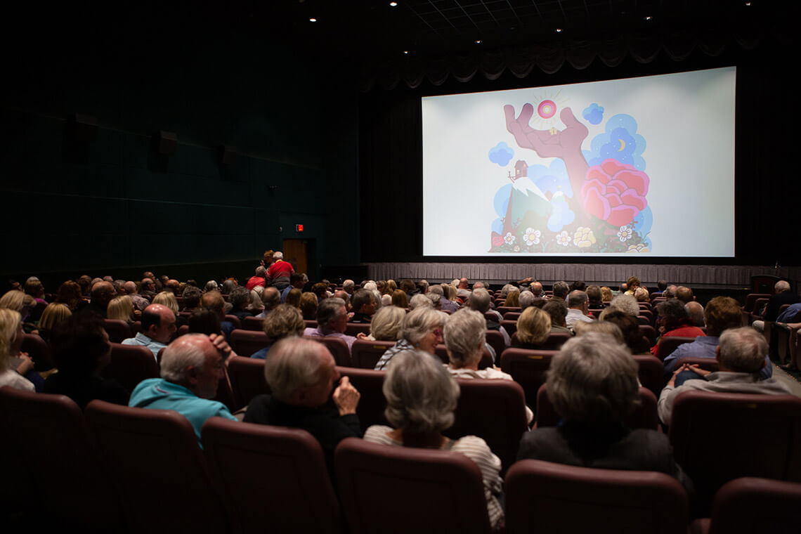 People watch a screening from the RiverRun International Film Festival