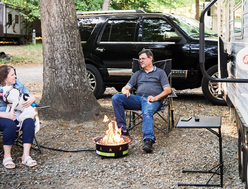 Lisa and Don sit outside their camper