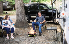 Lisa and Don sit outside their camper