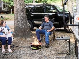Lisa and Don sit outside their camper