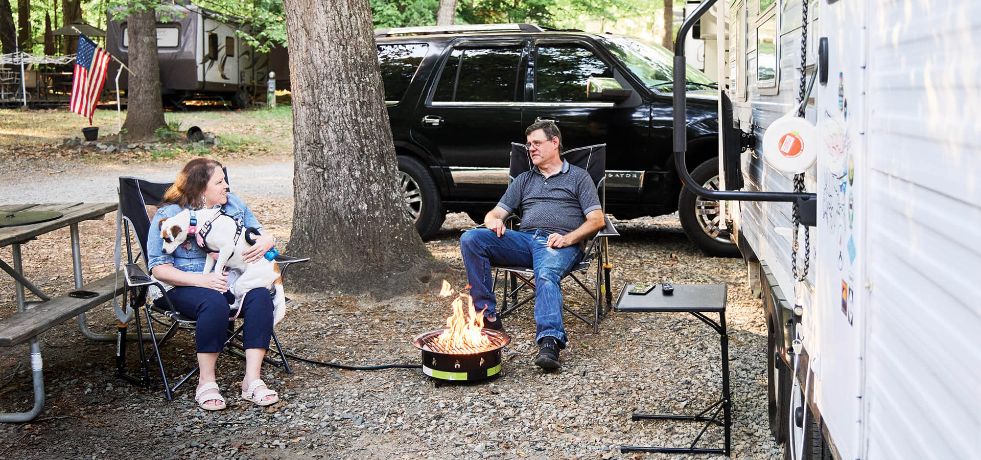 Lisa and Don sit outside their camper