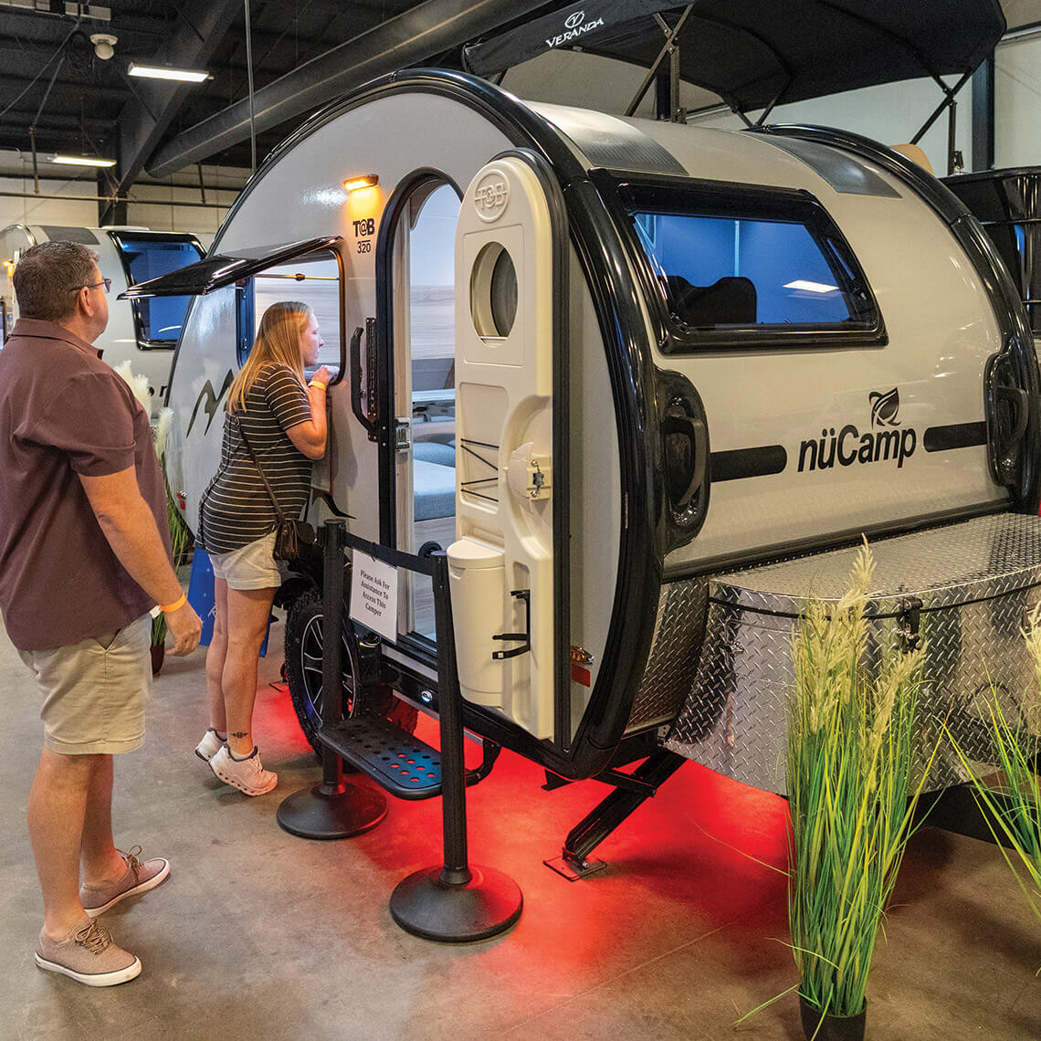 Couple checks out NuCamp camper at the RV show