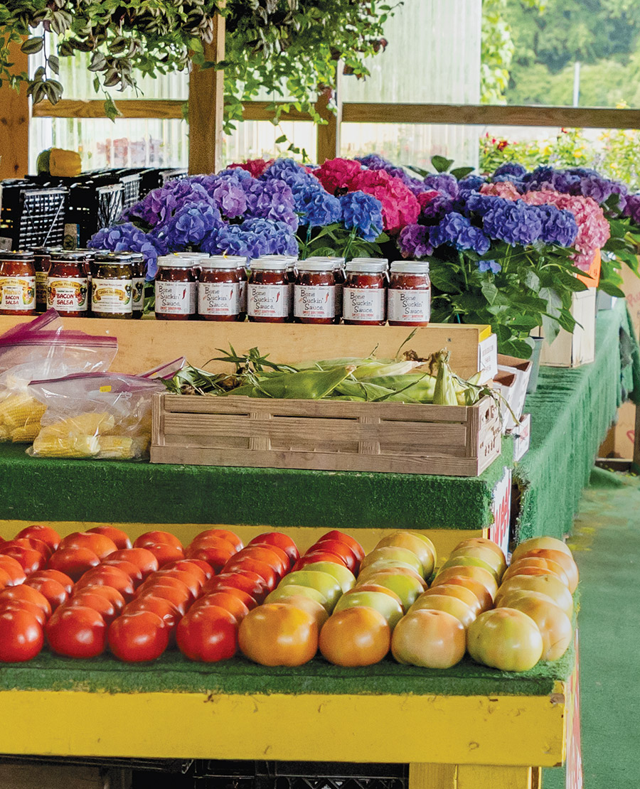 Barbecue sauce, tomatoes, corn, and flowers at Country Fruit Stand No. 2
