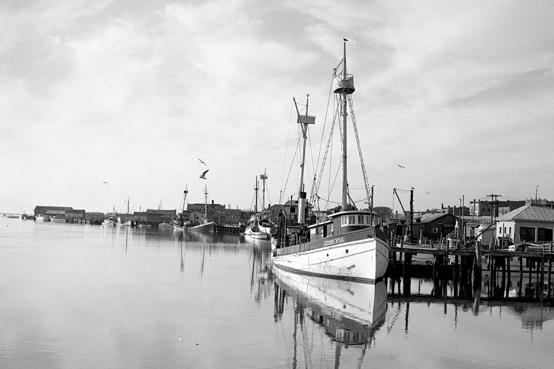 Black and white photo of boat on Beaufort's waterfront
