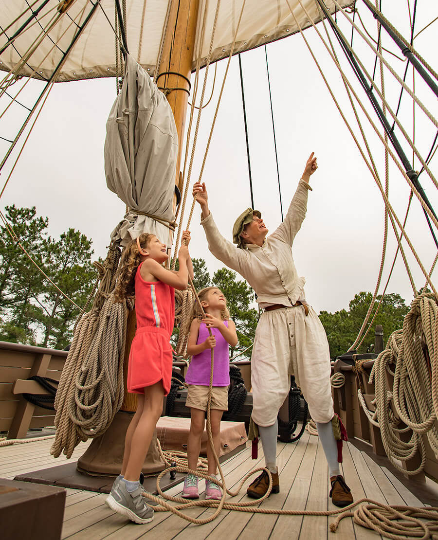 Children and re-enactor aboard the Discovery