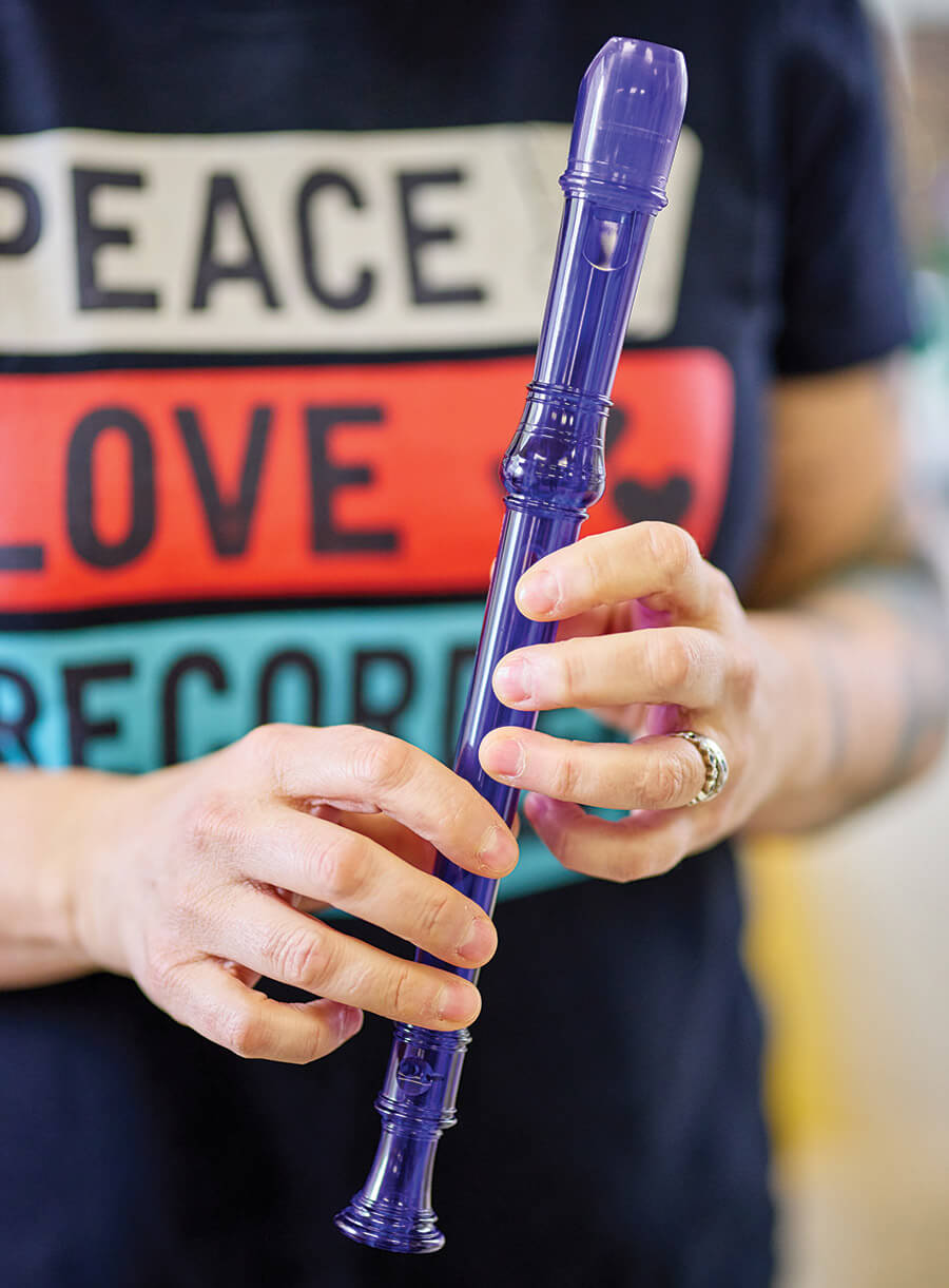 Hands hold the recorder