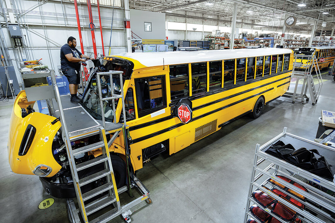 D'Angelo Payne checks school bus at Thomas Built Buses