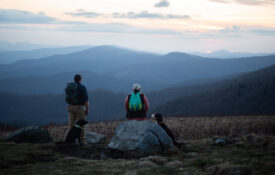 People look out at mountain views