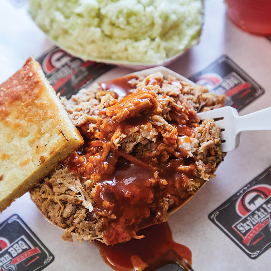 Container of barbecue and cornbread