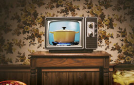 TV dinner on a plate in front of a vintage television set