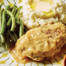 Plate with Salisbury steak, green beans, and potatoes